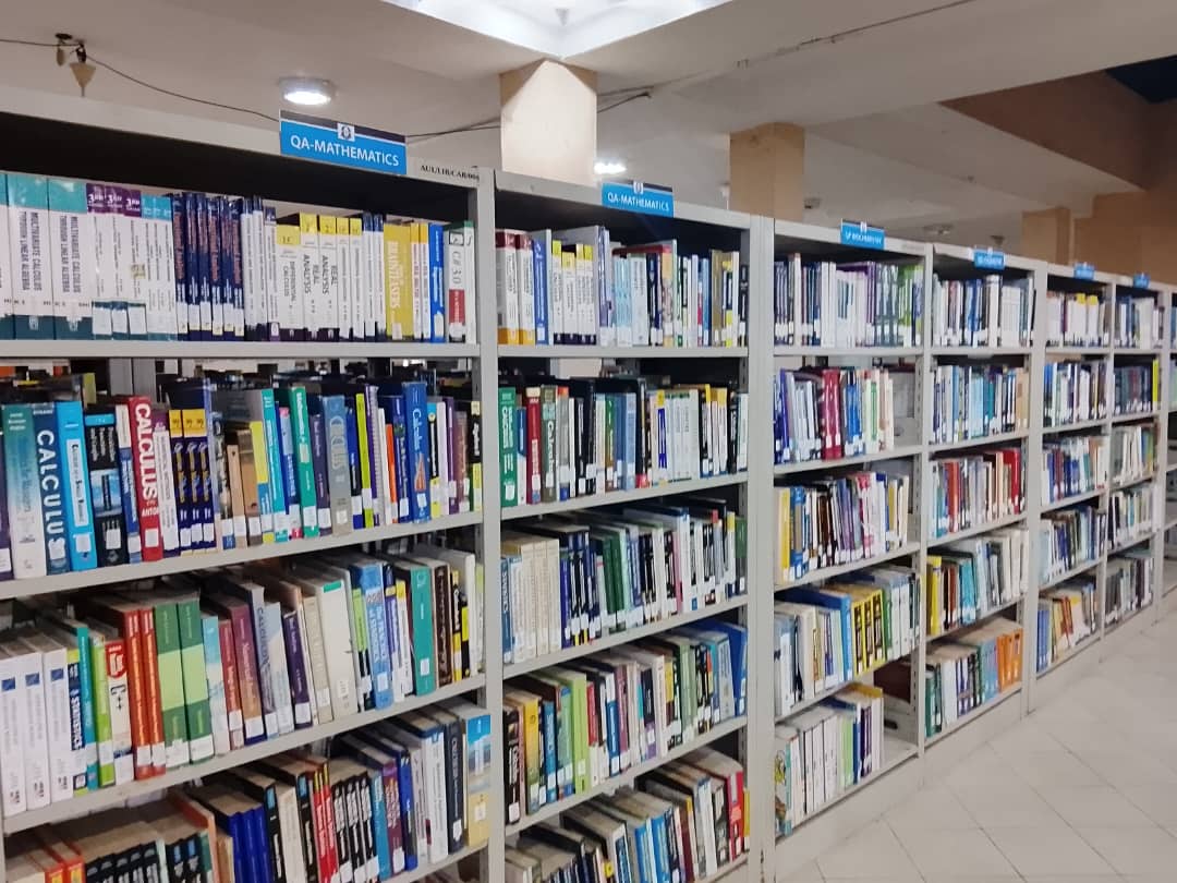 Rows of book shelves in the main library