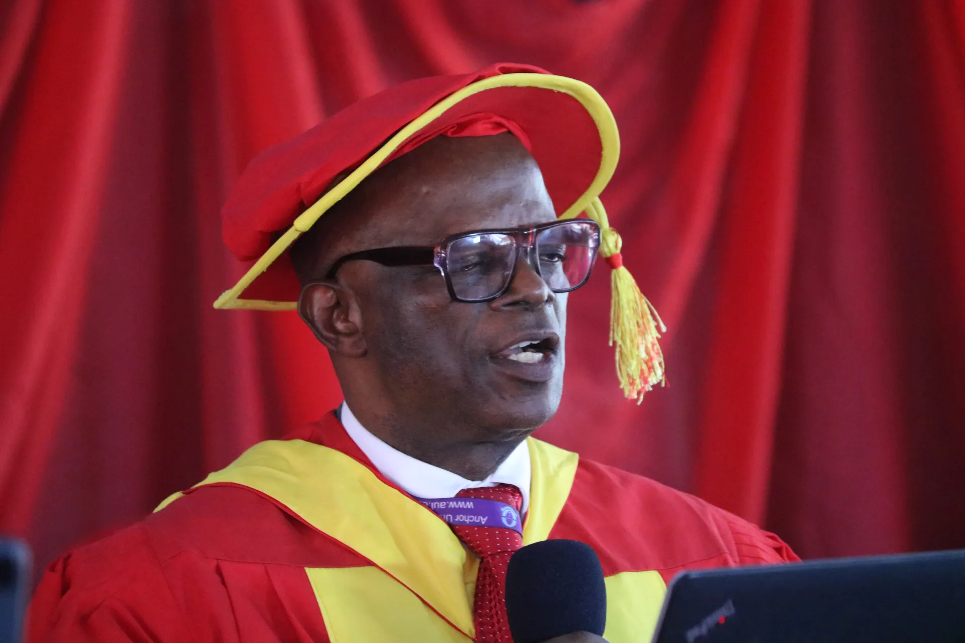 Speaker in academic regalia at an IBTC affiliation ceremony