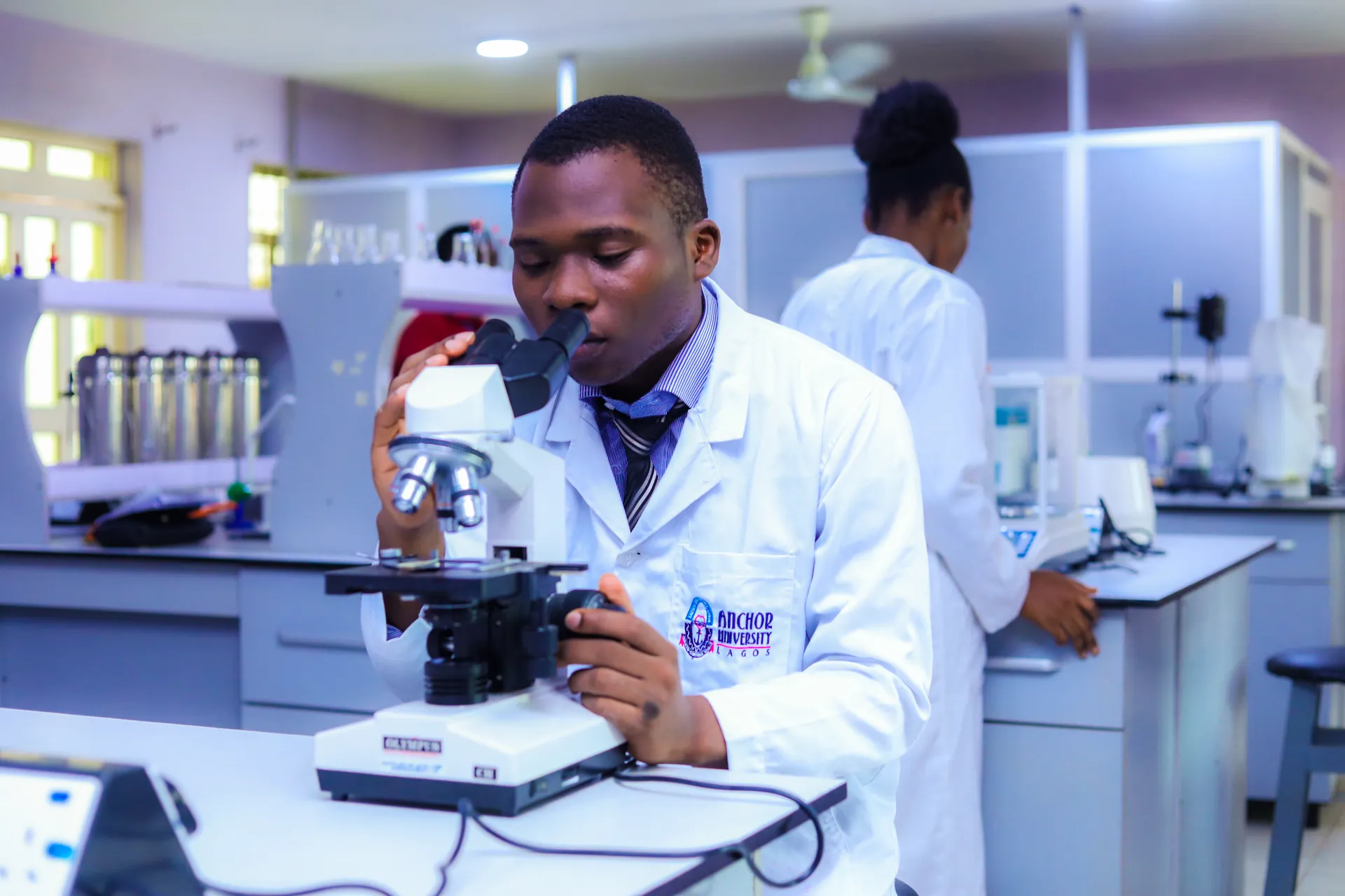 Student using a microscope in a laboratory