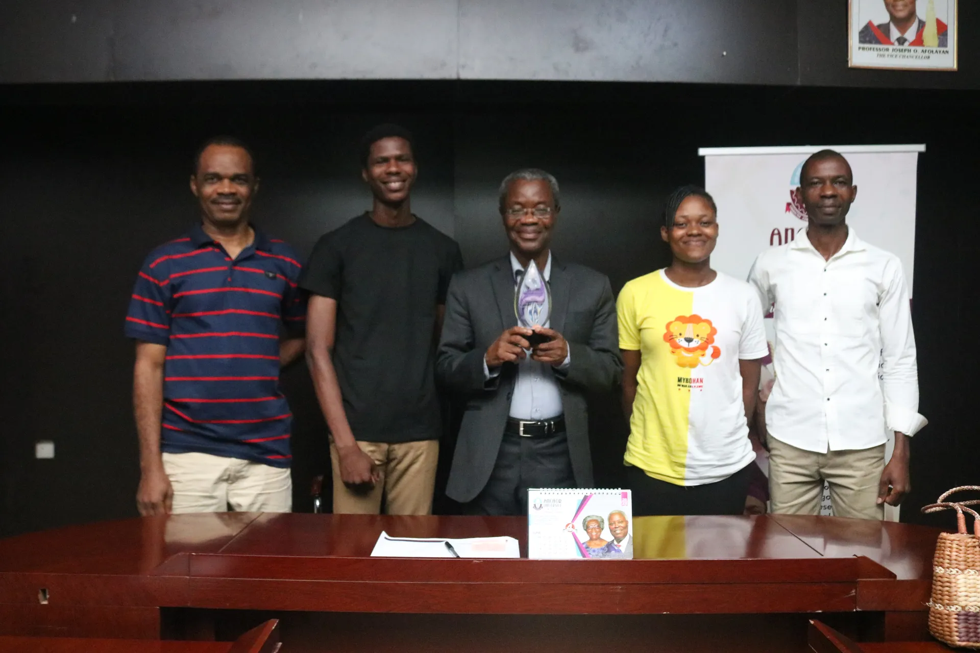 Award recipients posing with university representatives