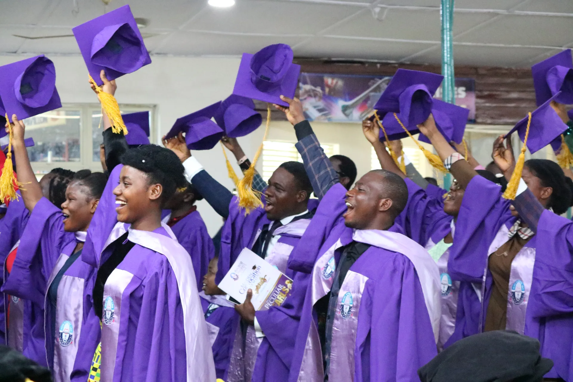 Graduates celebrating with their caps raised