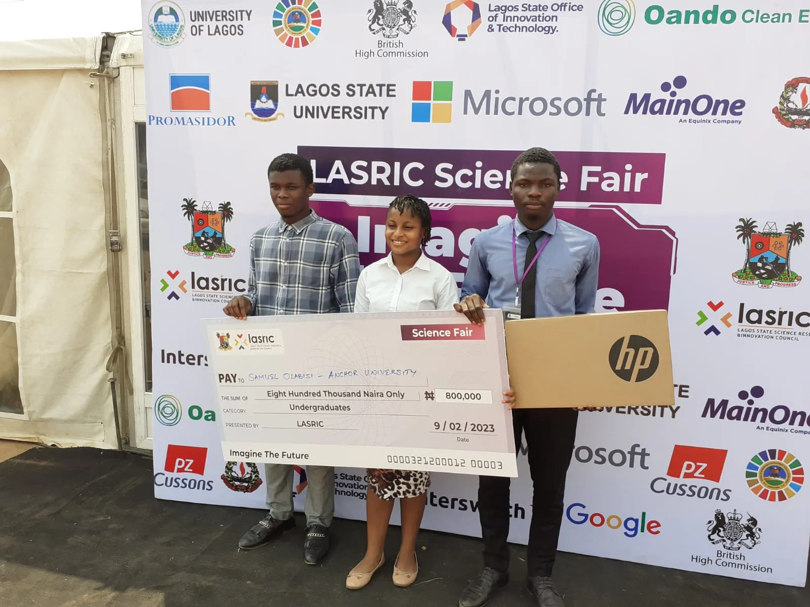 Award recipients displaying prizes at a science fair
