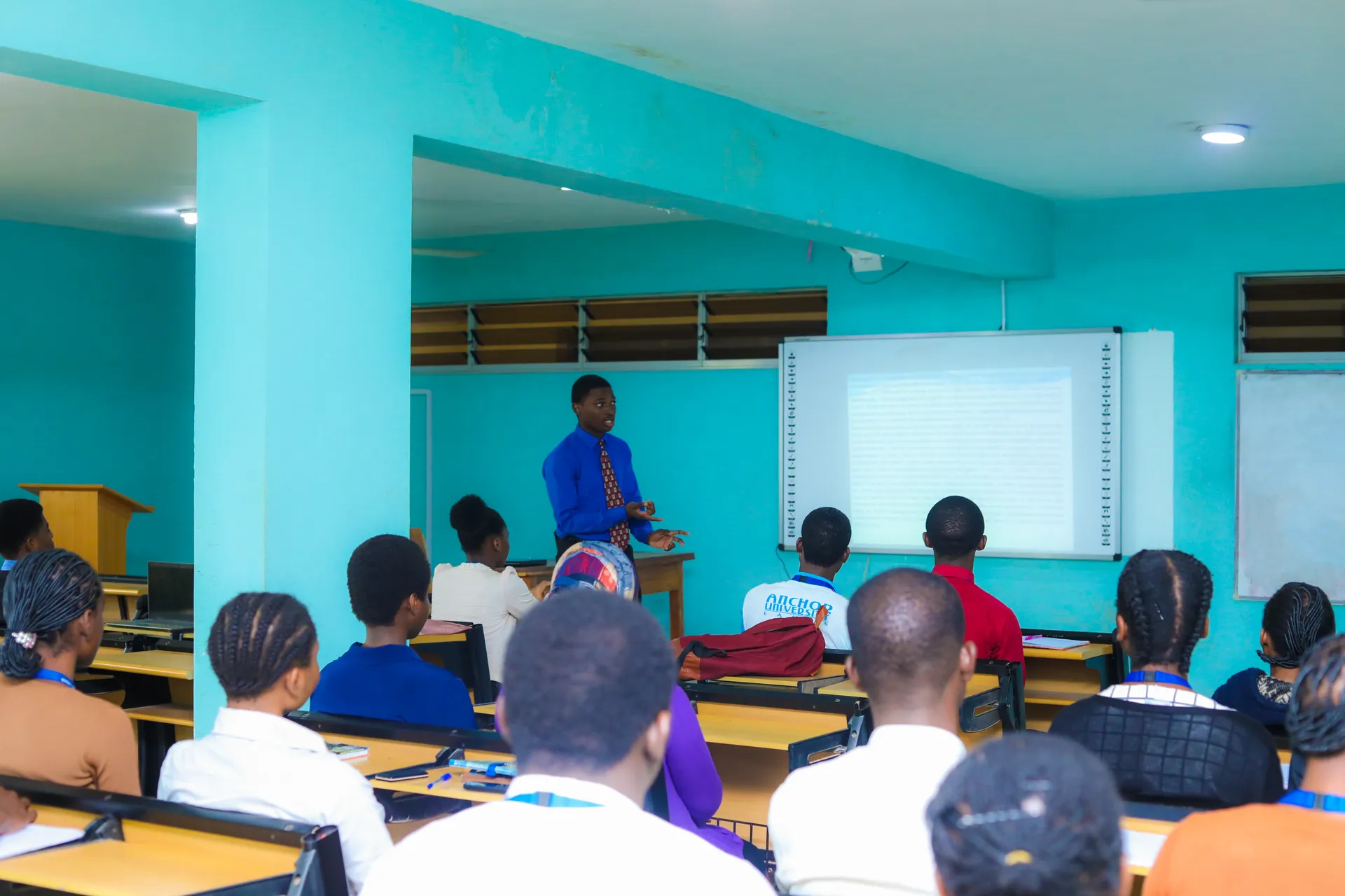 Lecturer teaching students seated in a classroom