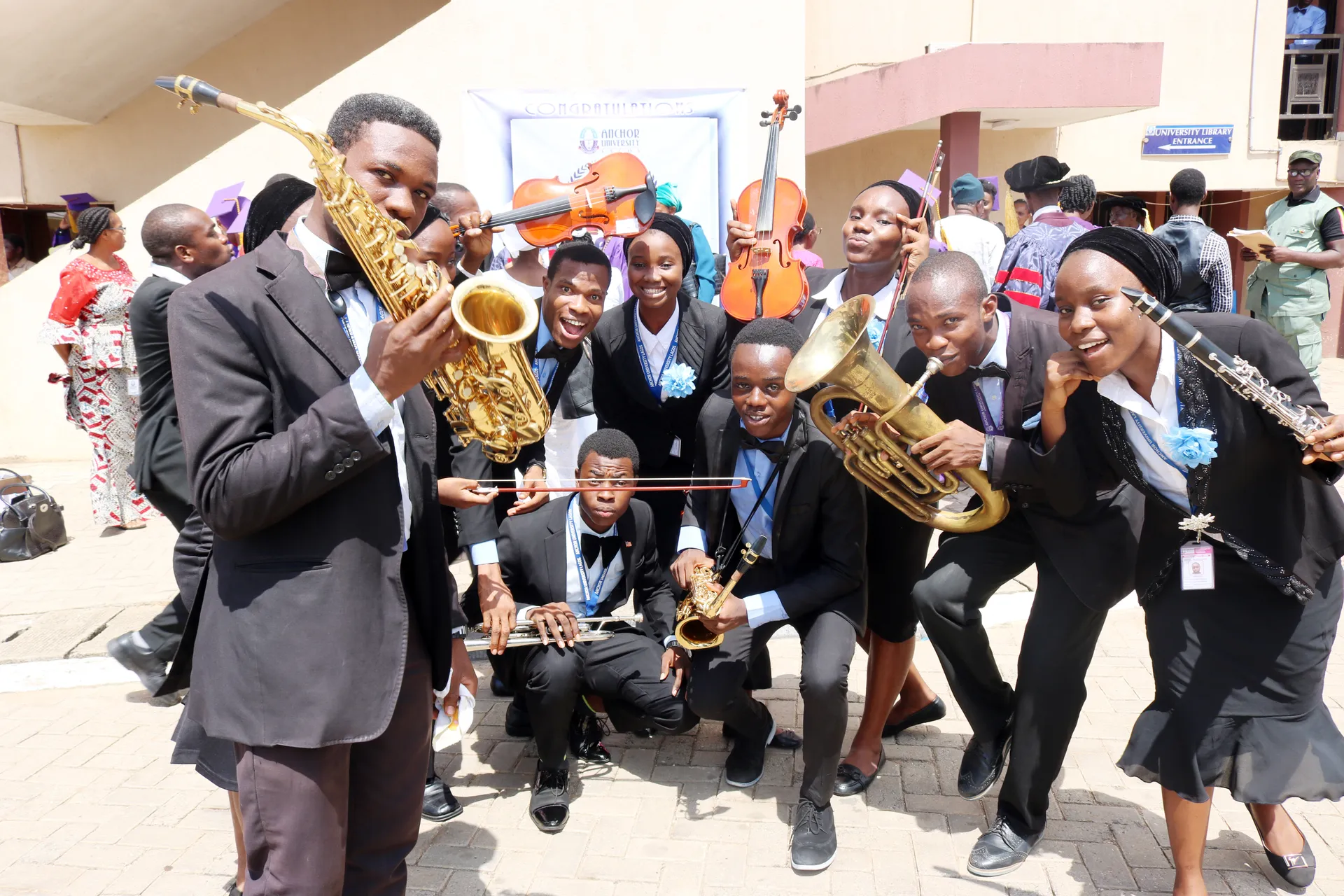 Students posing with brass and woodwind instruments