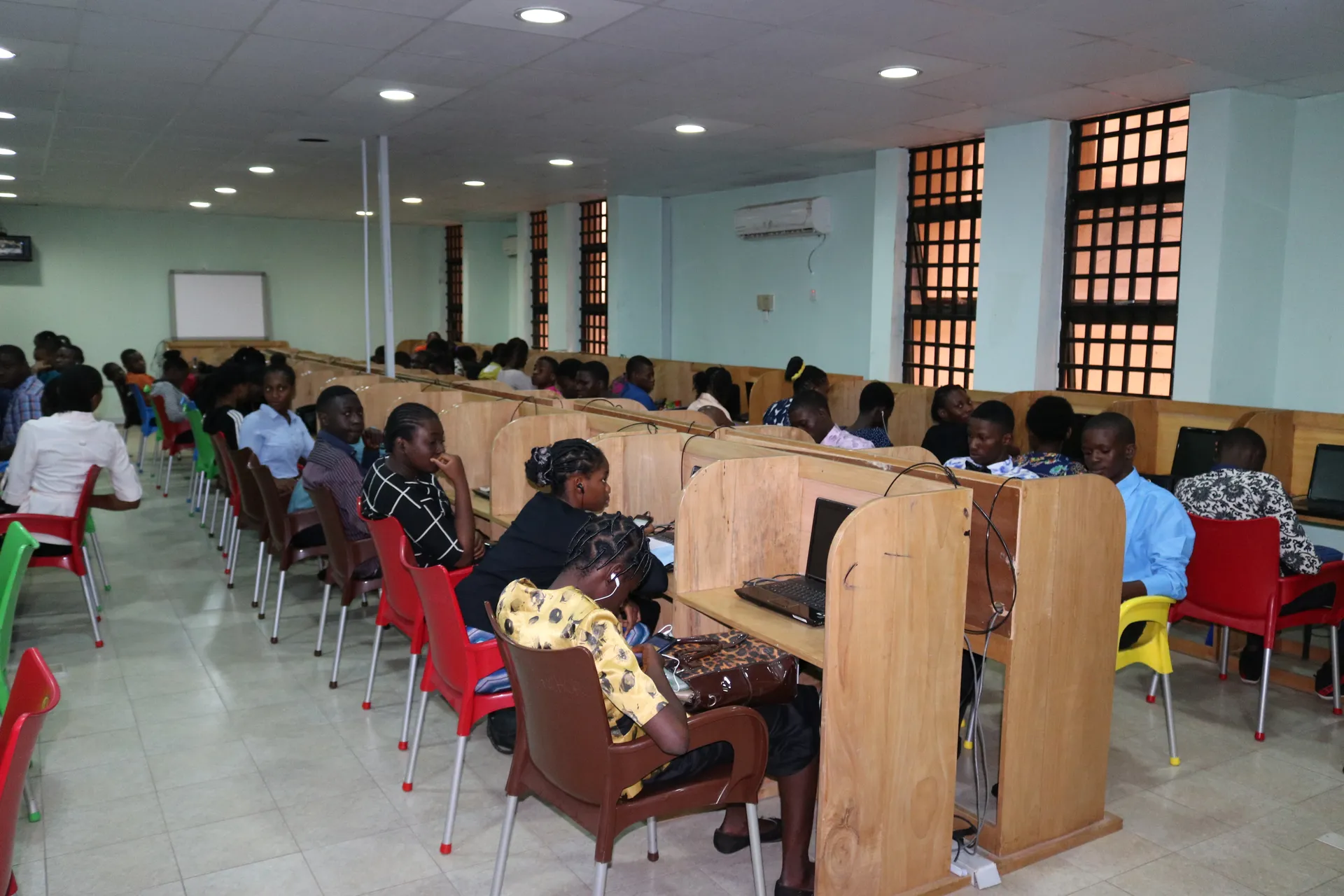 Students reading at library study desks